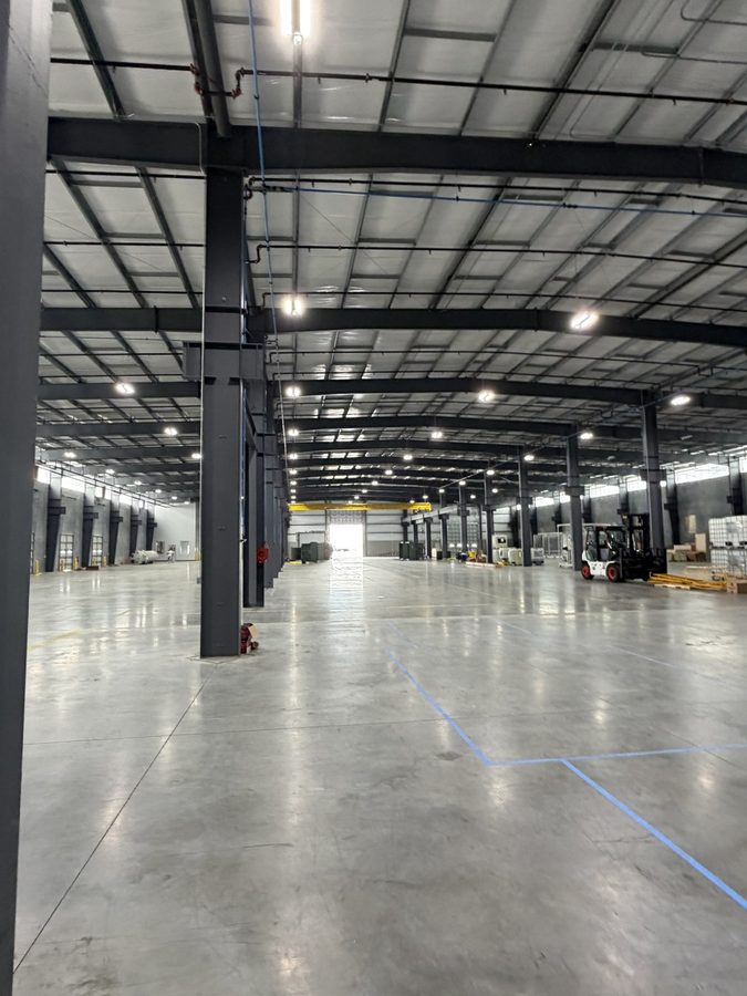 Finished warehouse interior lit by rows of new high-bay LED fixtures
