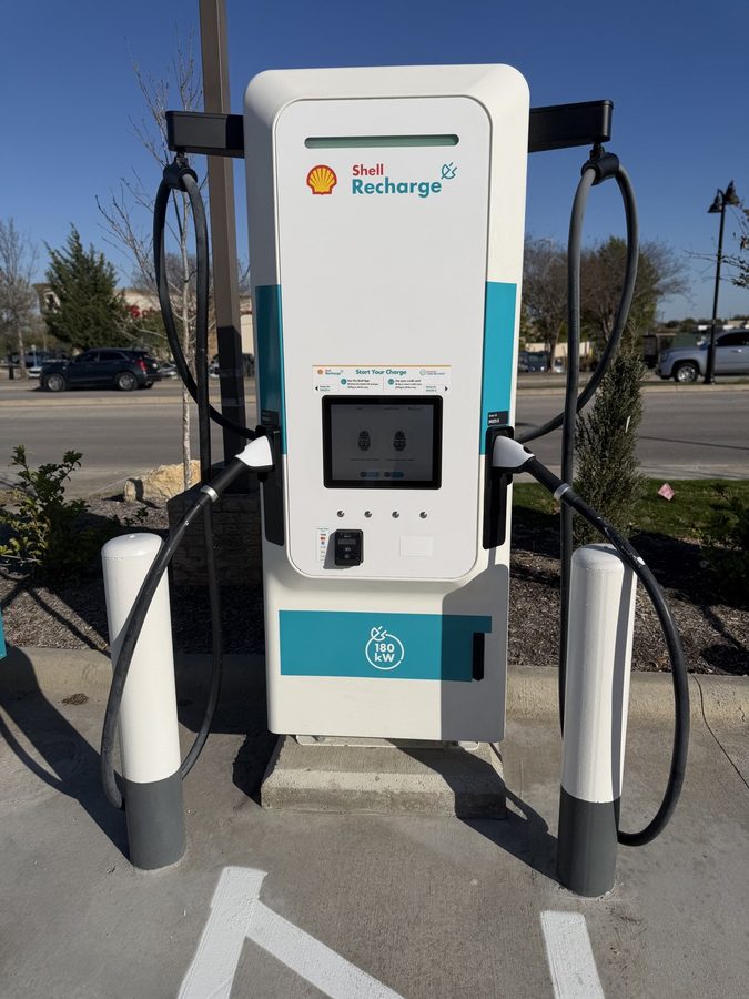 Dual-port DC fast charger installed in a parking lot, shot square on