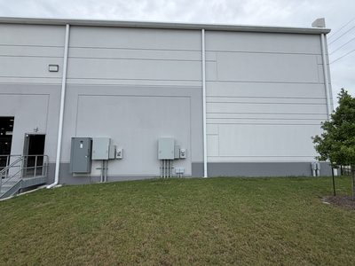 Building corner with two panel and meter clusters, wide angle