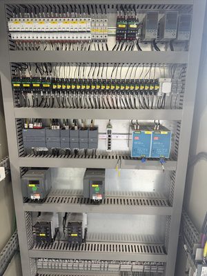 Densely populated control panel with every breaker labeled and the DIN-rail components neatly arranged