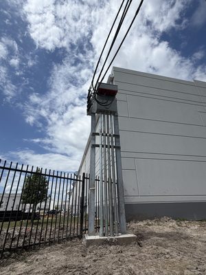 Low angle view of a galvanized service riser and meter cabinet against a building wall