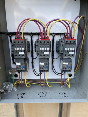 Three combination motor starters wired with color-coded conductors and full-load amp values marked