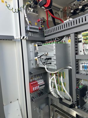 Red DIN-rail surge protection modules installed inside a clean equipment cabinet with organized wiring